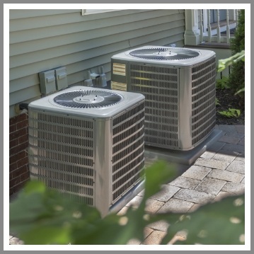 2 air conditioning units outside of a home